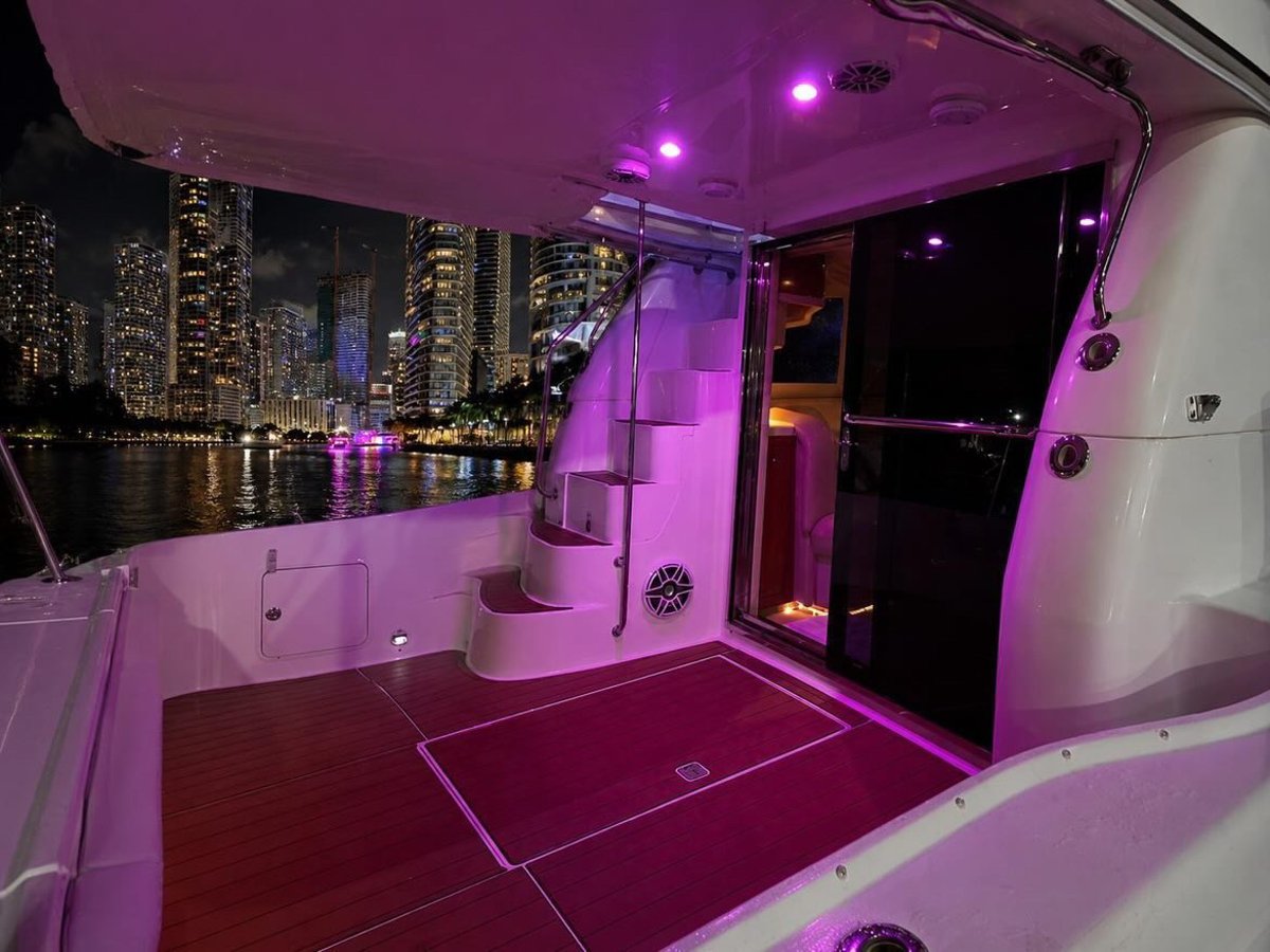 King Leisure deck lit up at night with Miami skyline