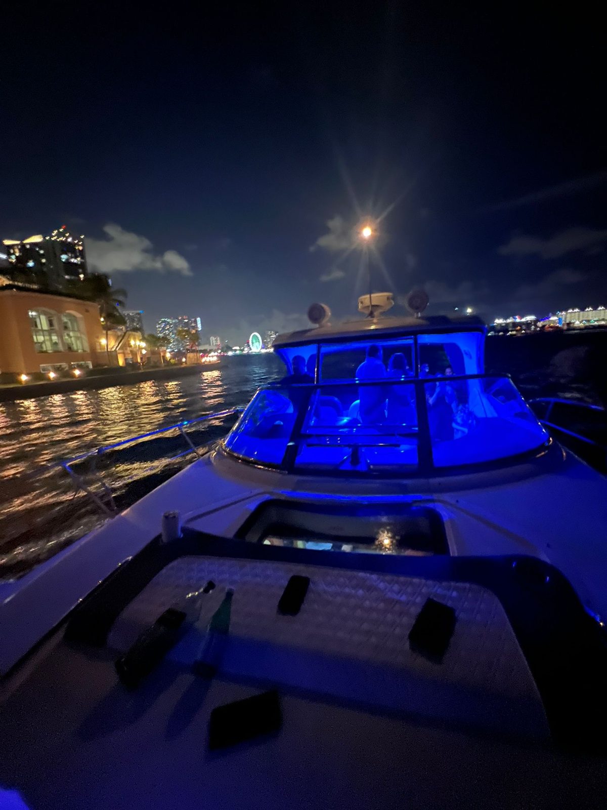 Sea Ray Sundancer bow lit up at night, Miami skyline